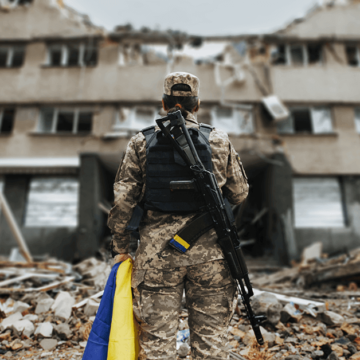 soldier standing infront of destroyed building